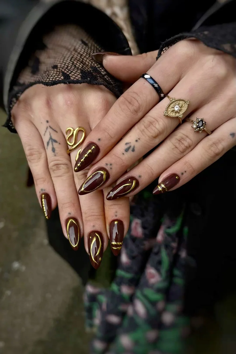 Burgundy stiletto nails with gold accents