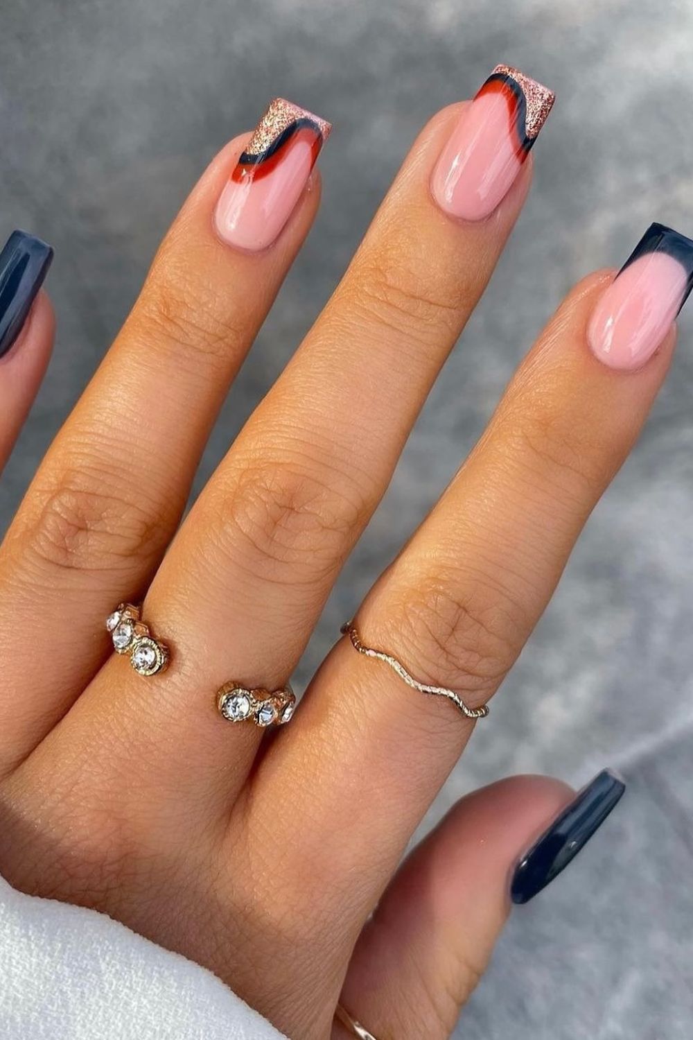 Nail art with abstract swirls and French tips
