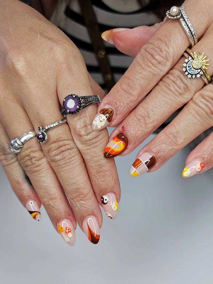 Autumn-themed nail art with various designs