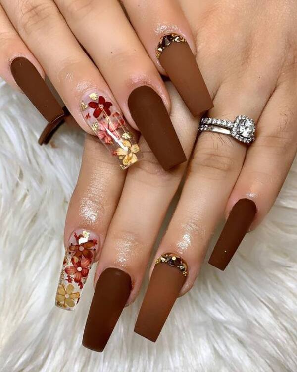 Matte brown nails with floral accents