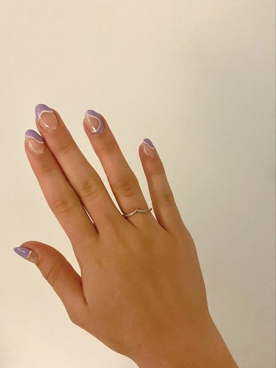 Pastel lavender swirl designs on short rounded nails.