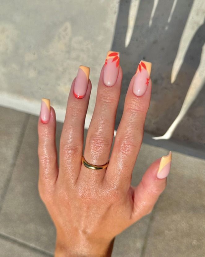 Pastel peach and coral swirl designs on square nails.