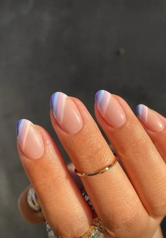 Gradient pastel stripes on almond-shaped nails.