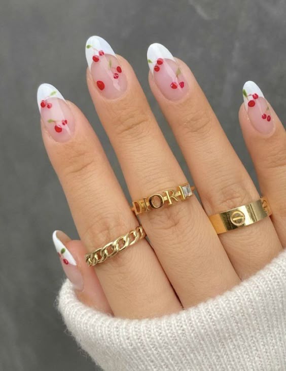 French tips with cherry accents on almond nails.