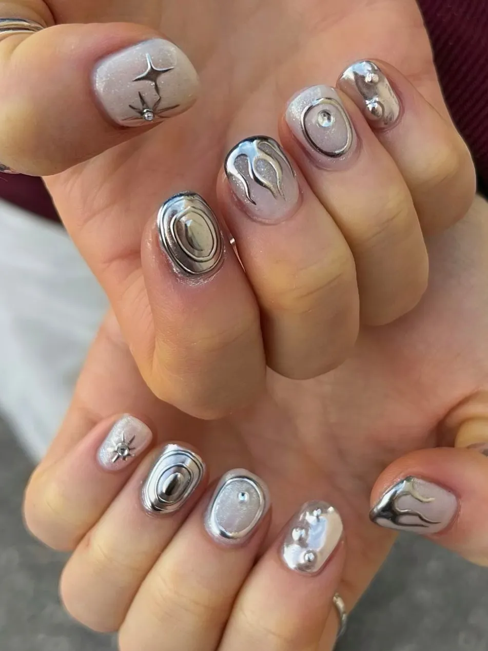Short nails with metallic silver accents.