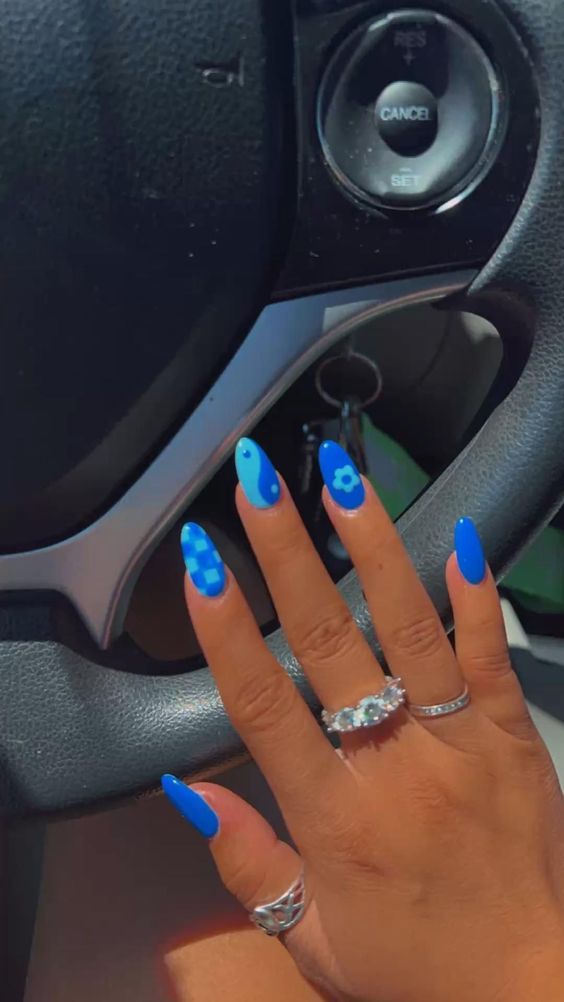 Almond nails with blue graphic design.