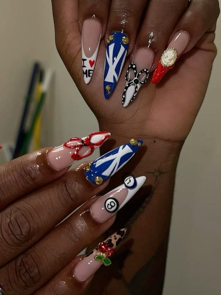 Long stiletto nails with nautical and graphic designs.