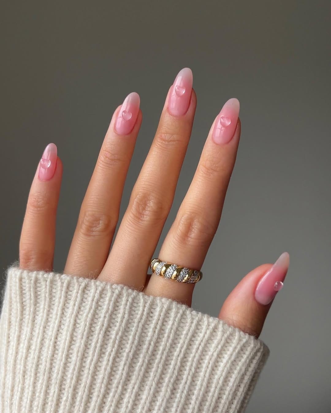 Soft pink almond nails with heart accents