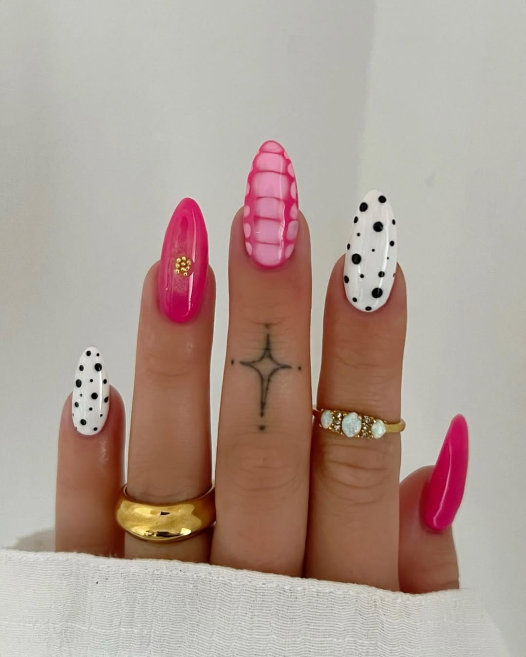 Pink and white almond nails with polka dots