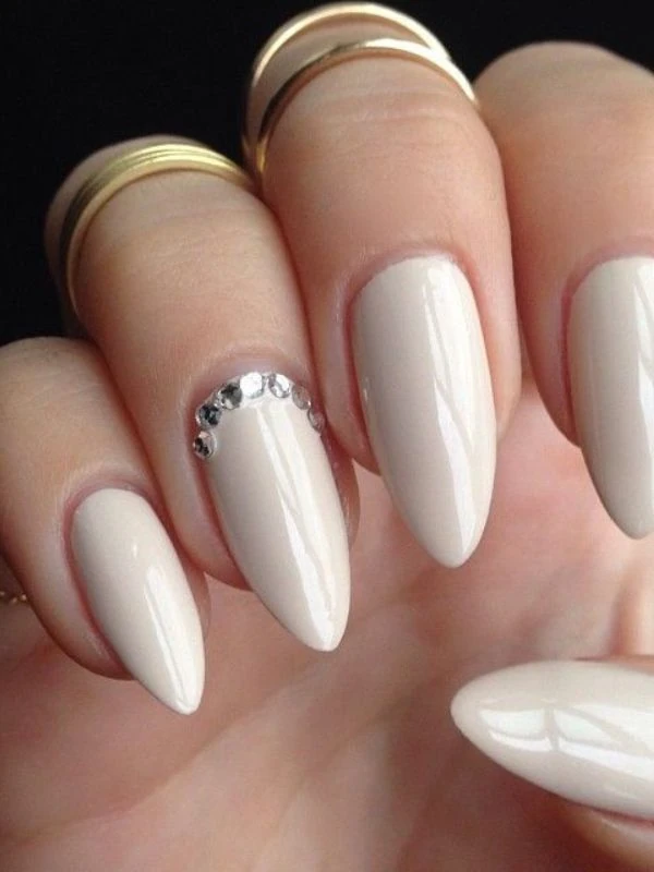 Ivory nails with crystal accents, elegant autumn manicure