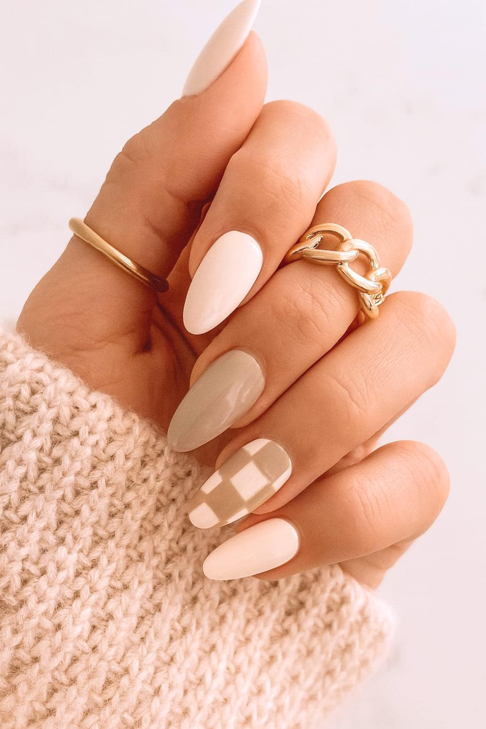 Almond neutral nails with geometric accent, chic autumn design