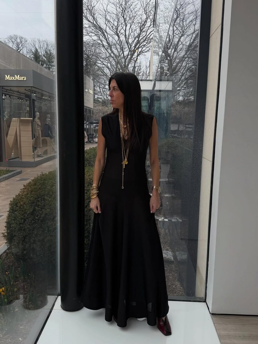 Black maxi dress with gold accessories in art setting