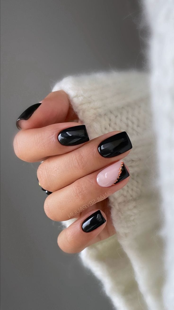 Glossy black nails with nude accent and gold detail