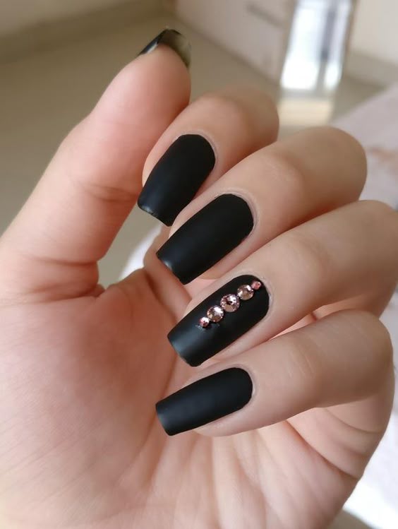 Long matte black nails with rhinestone accent