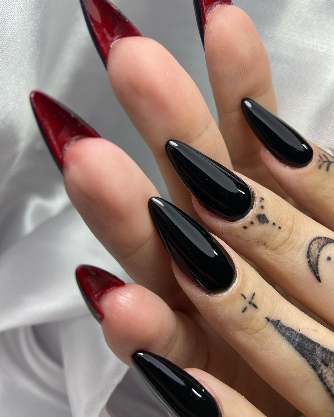 Stiletto black nails with red tips