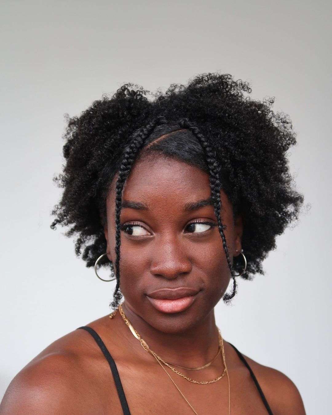 Afro texture with face-framing braids for Black women