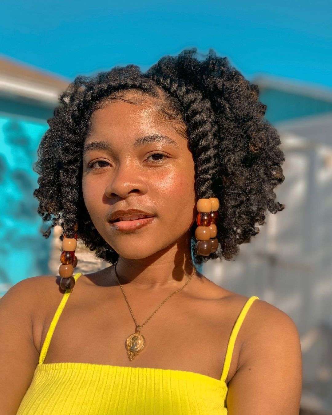 Twist-out hairstyle with beaded accents for Black women