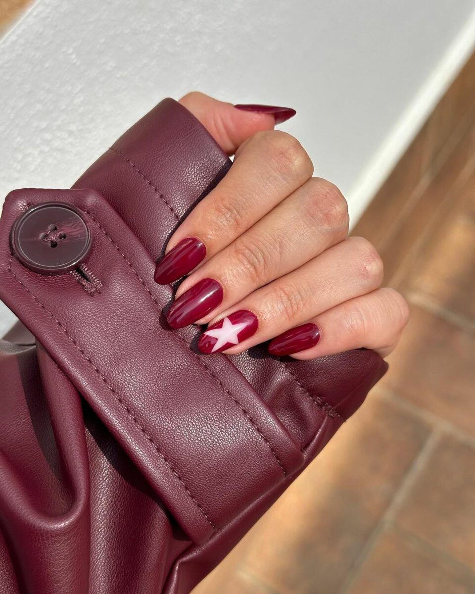 Burgundy nails with star accent, creative nail art