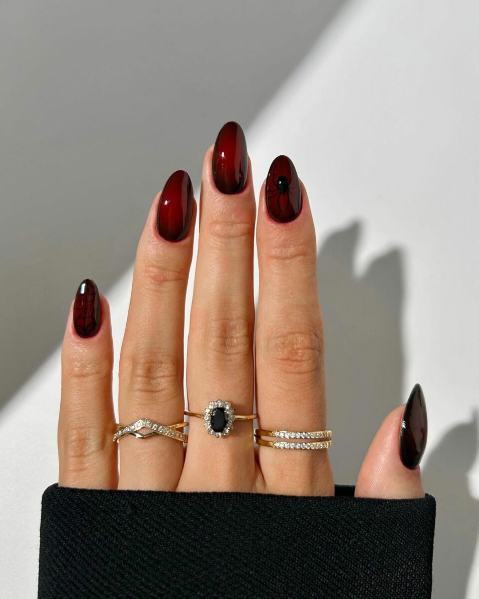 Dark burgundy nails with spider web detail, edgy nail art