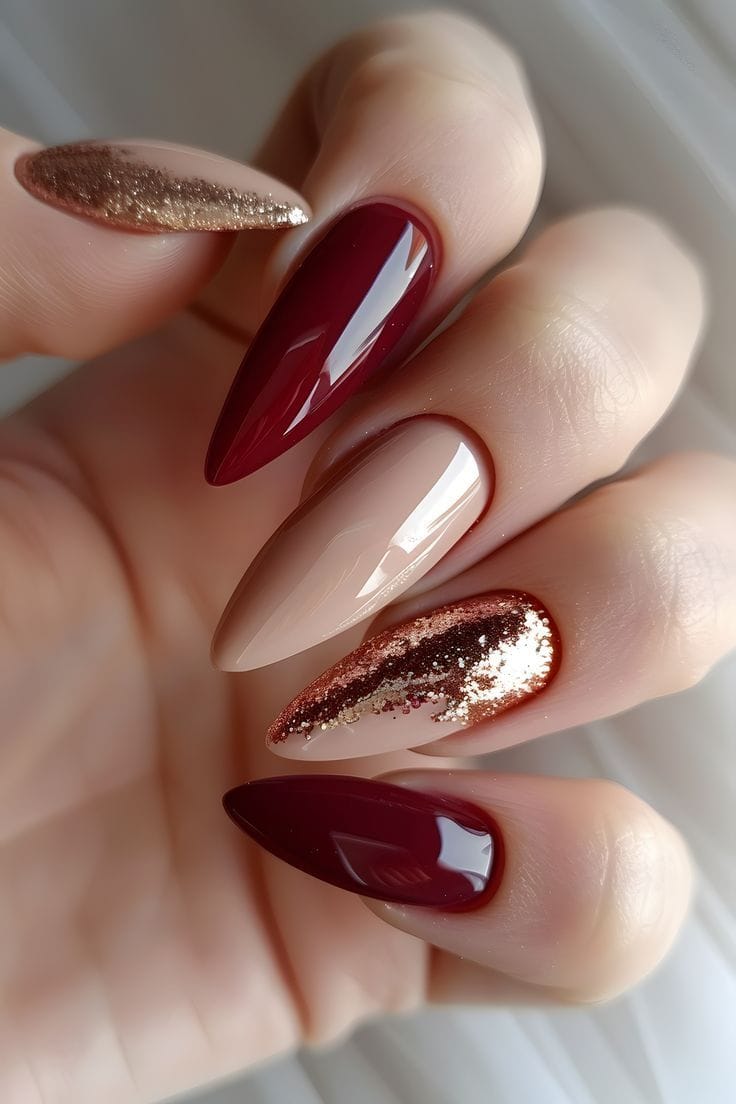 Burgundy and gold glitter almond nails, glamorous style