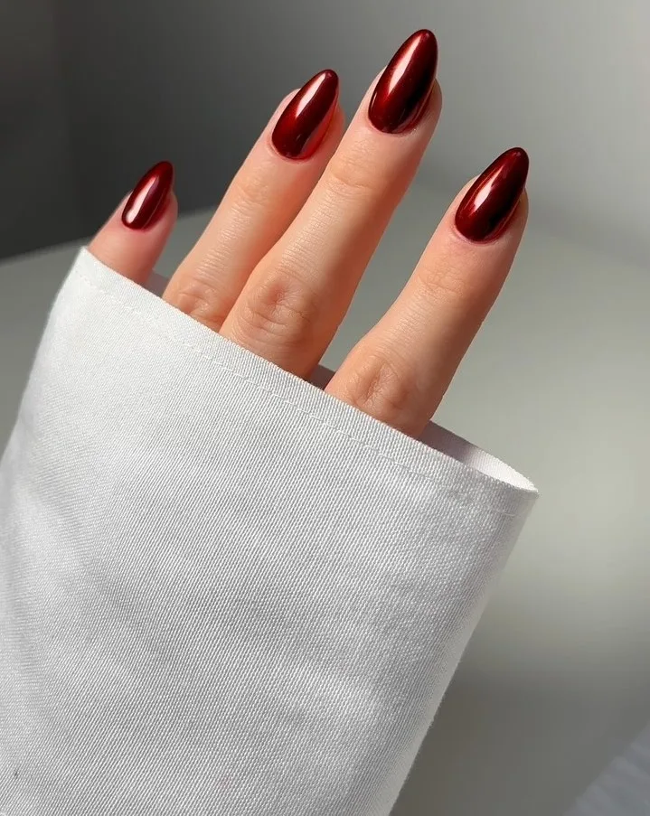 Metallic burgundy oval nails, sleek shine