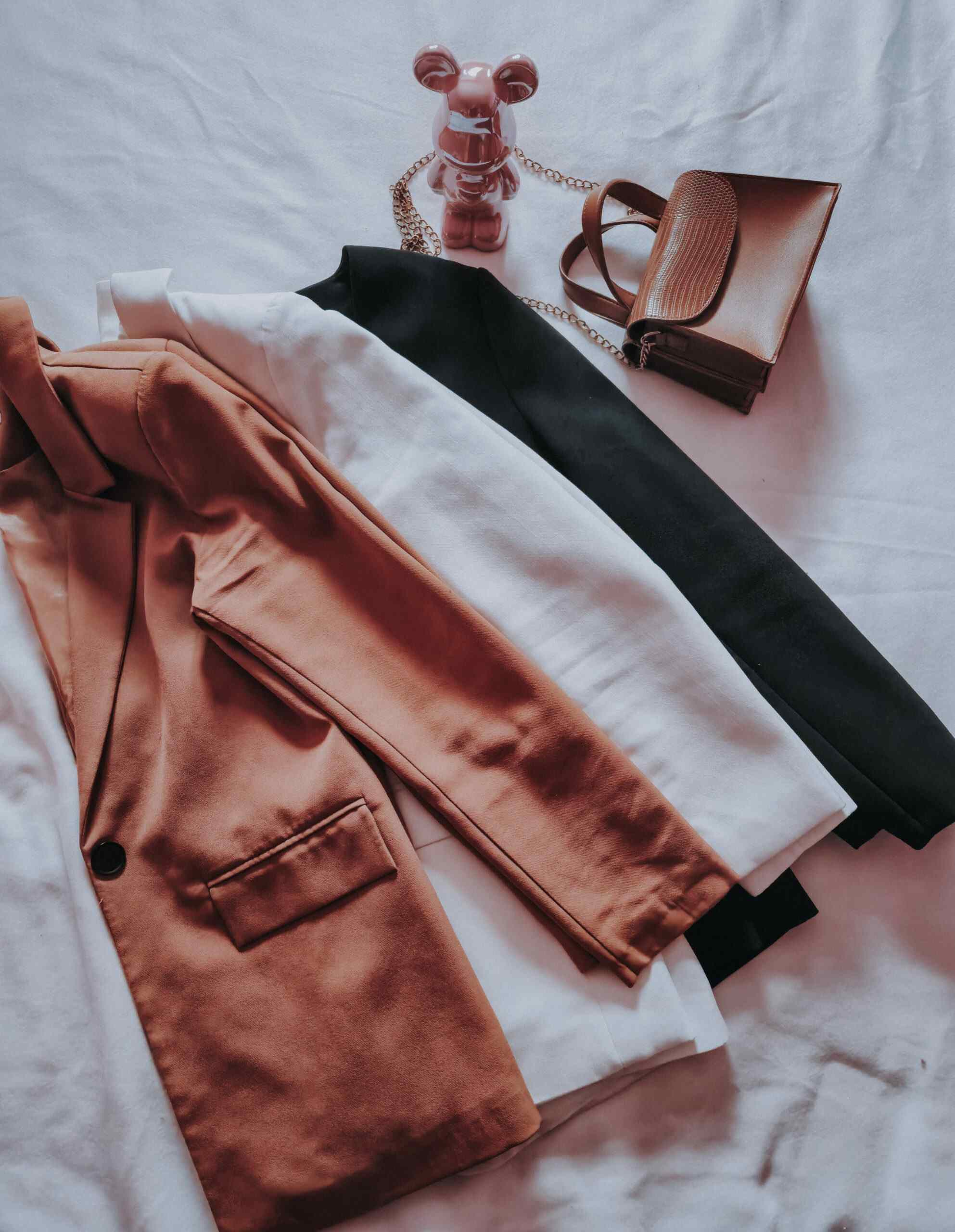 Neutral blazer selection in camel, white, and black
