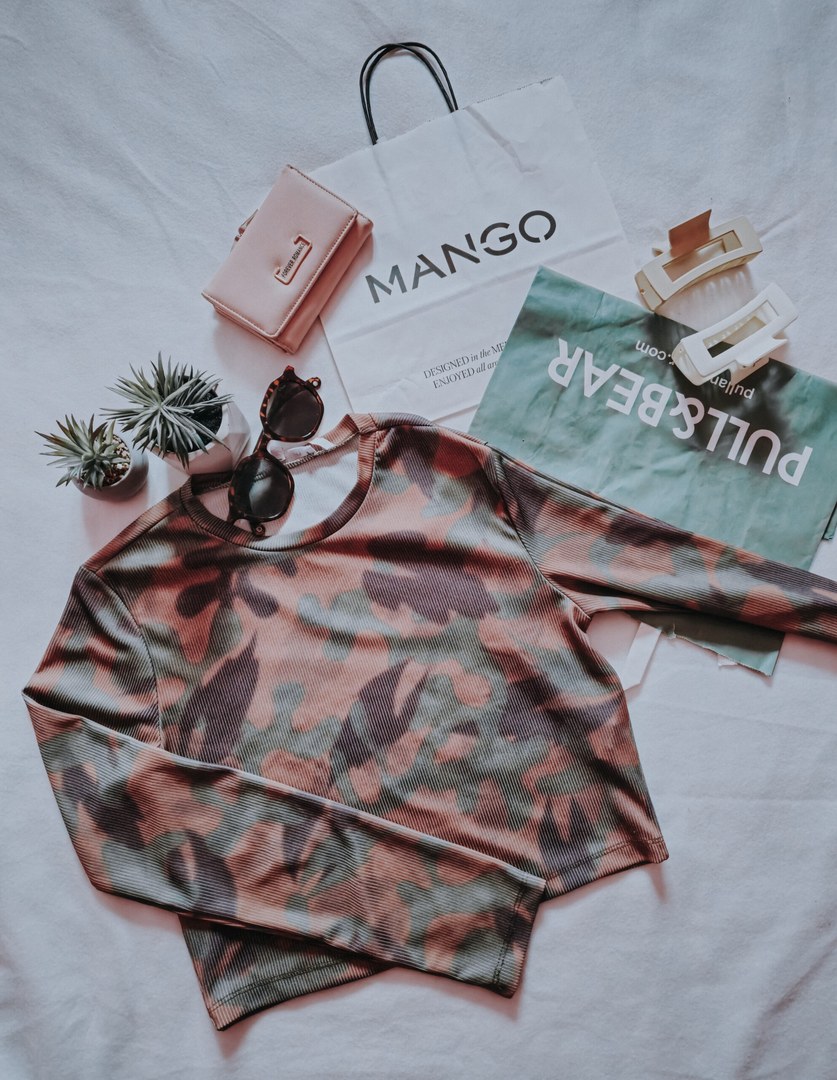 Camo print top with accessories flatlay