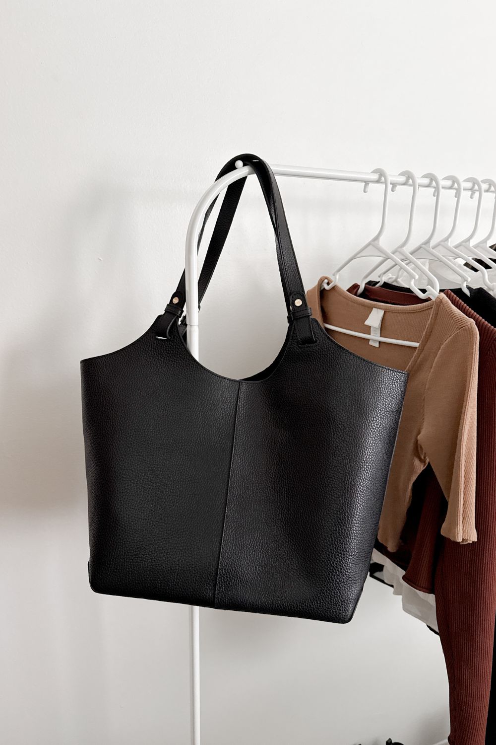 Black tote bag on a rack