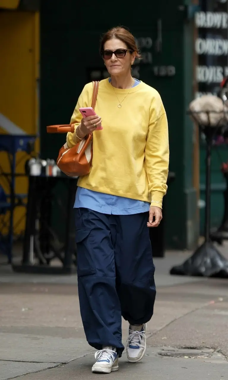 Yellow sweatshirt with navy pants, sporty casual