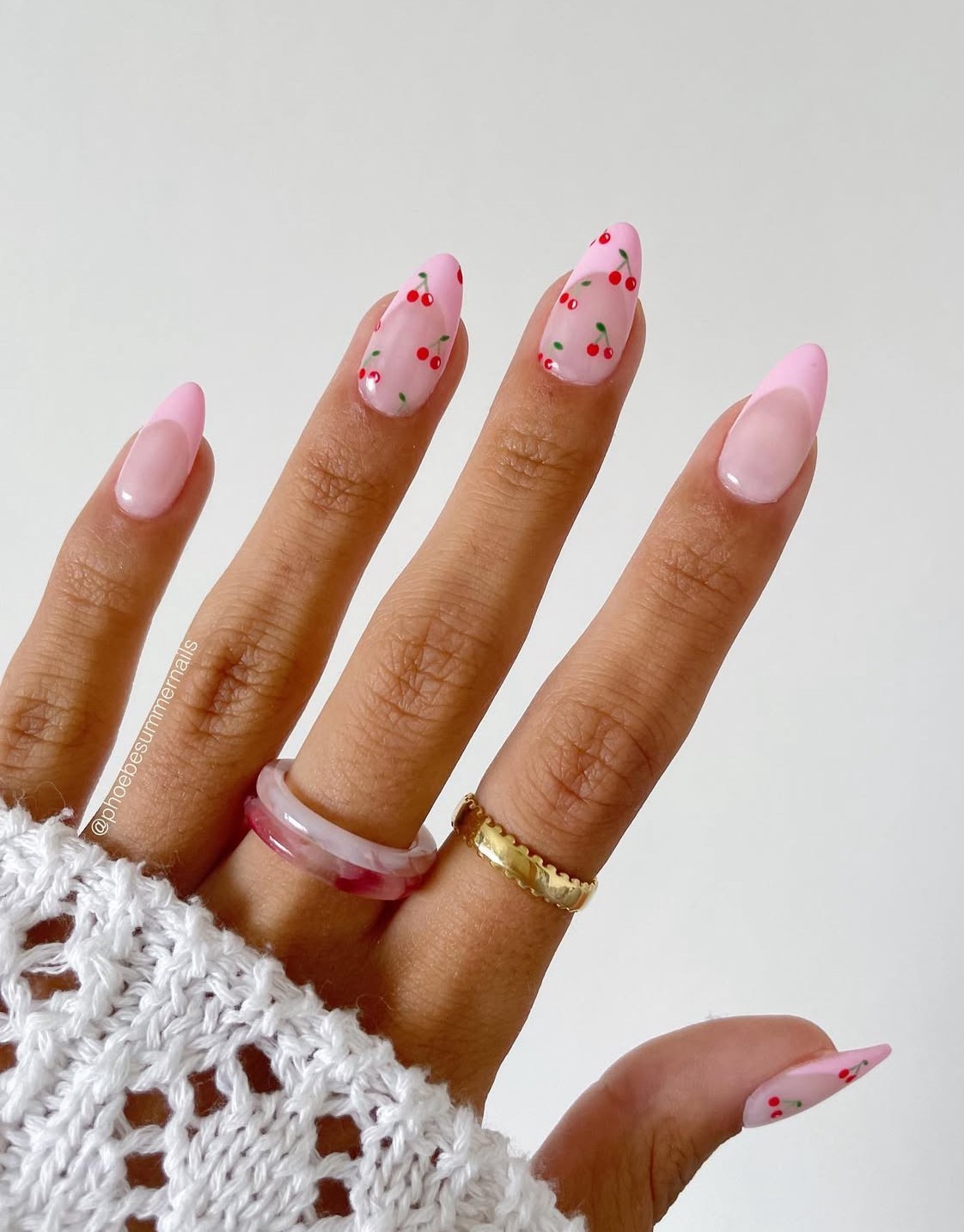 Almond nails with pink base and cherry dots
