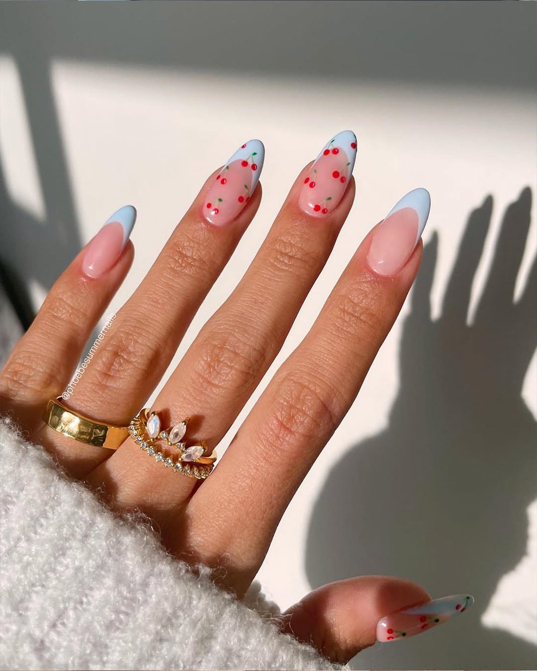 Almond nails with blue tips and cherry dots