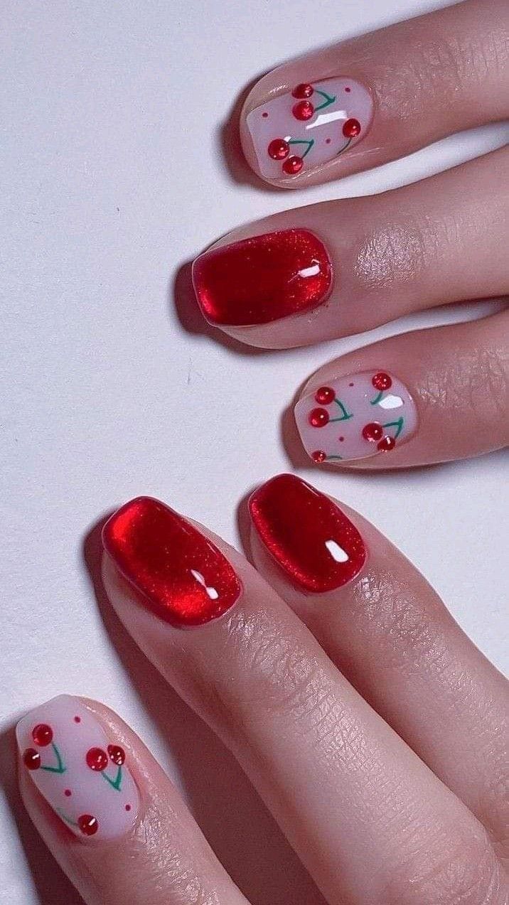 Short nails with red polish and cherry art