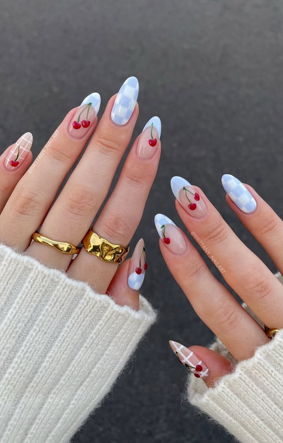 Almond nails with blue gingham and cherry design