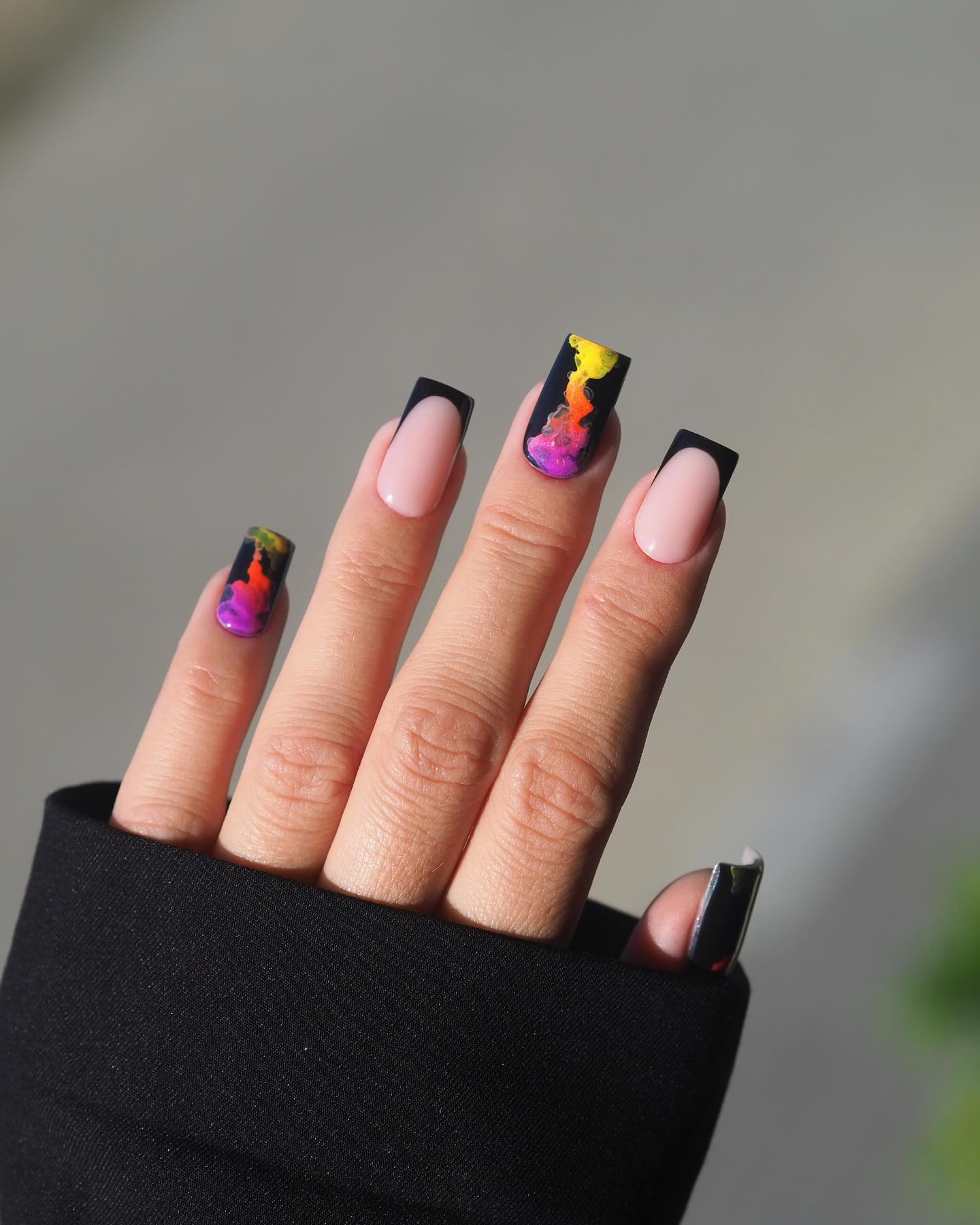 Neon abstract art on dark nails, vibrant fall statement.