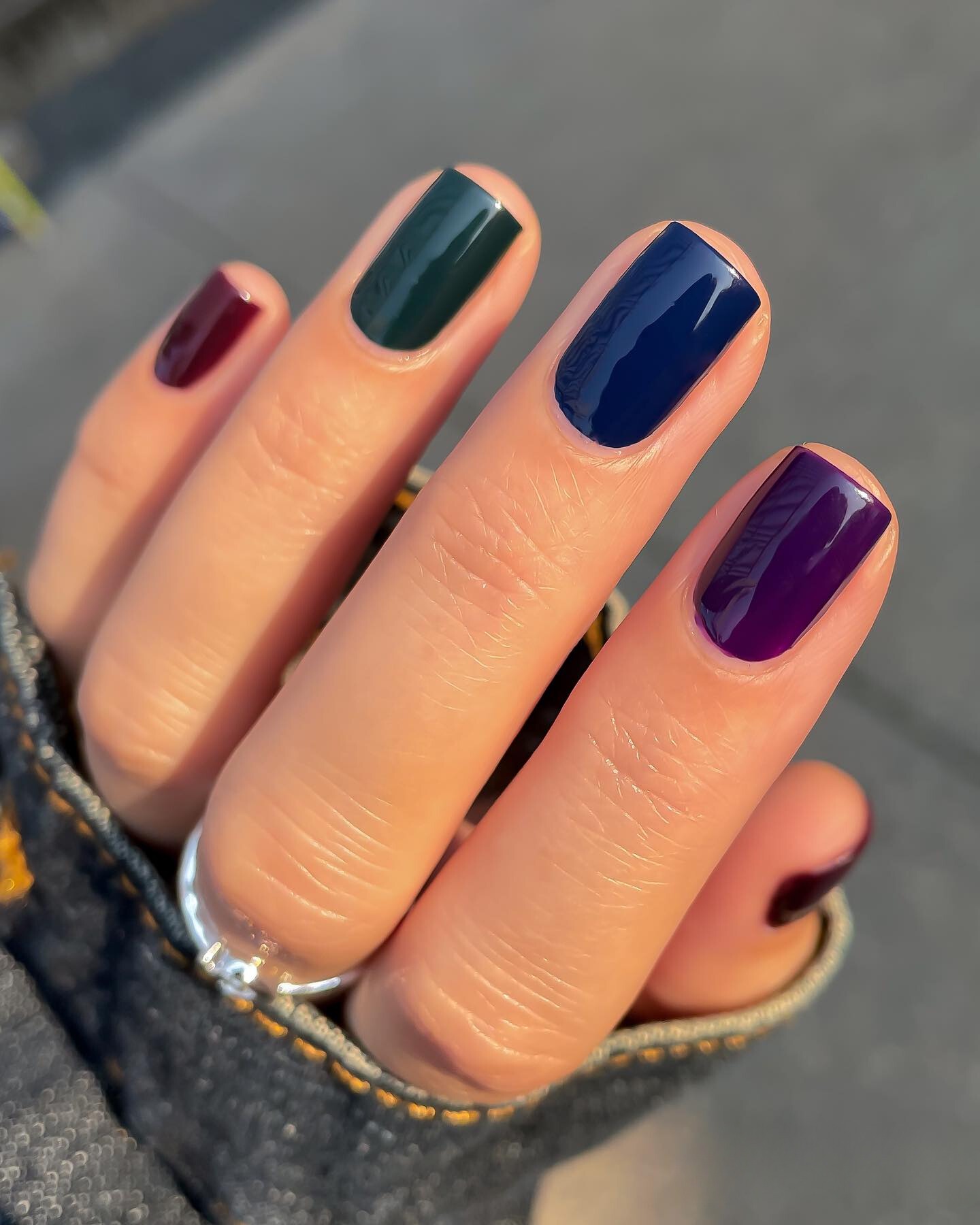 Deep multicolor nails in green, blue, and plum, chic for fall.