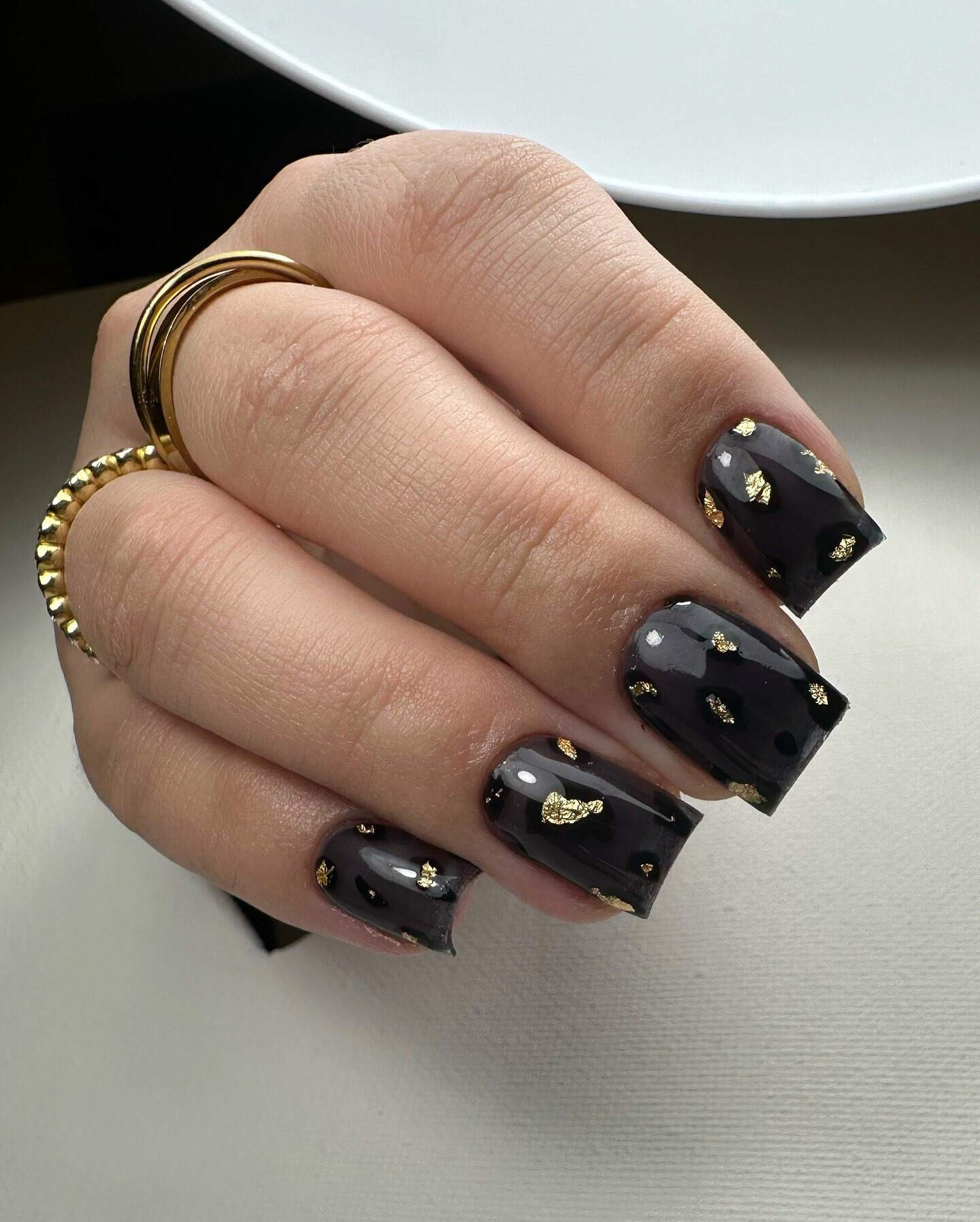 Black nails with gold flakes, bold fall statement.