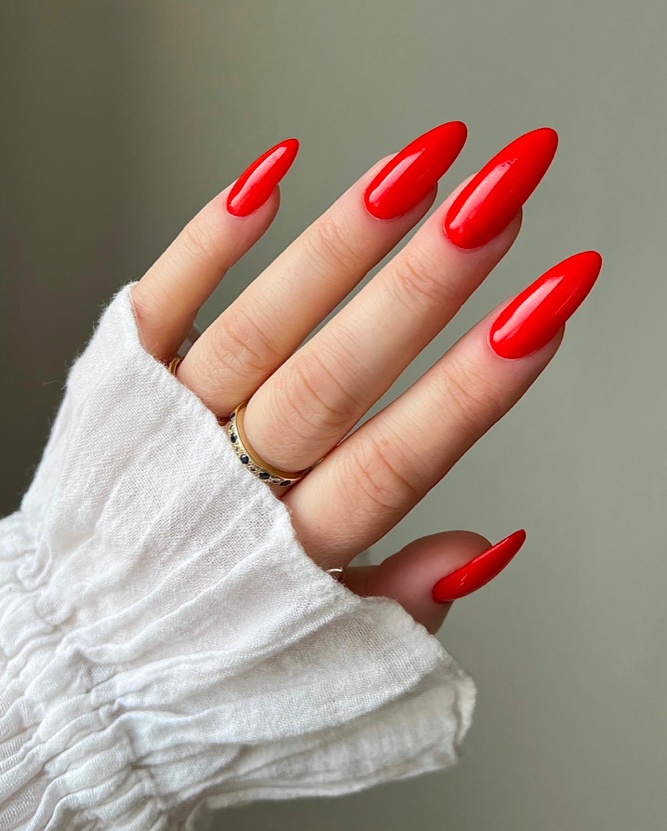 Vibrant scarlet almond nails, glossy, bold style