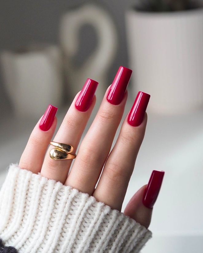 Bold red coffin nails, glossy, dramatic effect