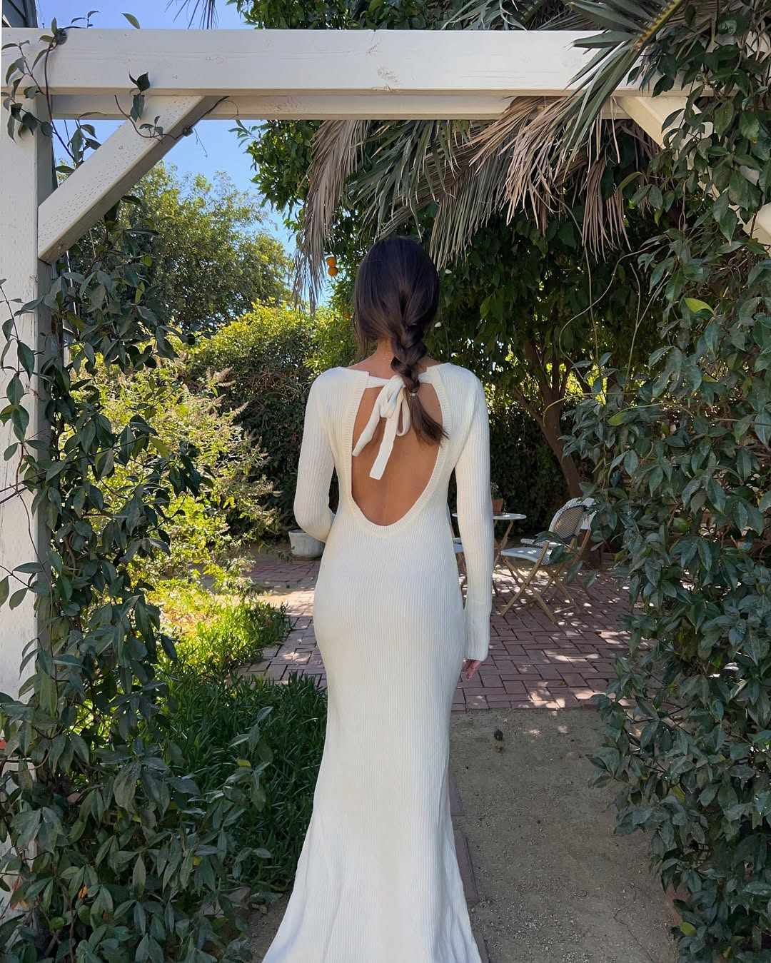 White backless knit dress in garden
