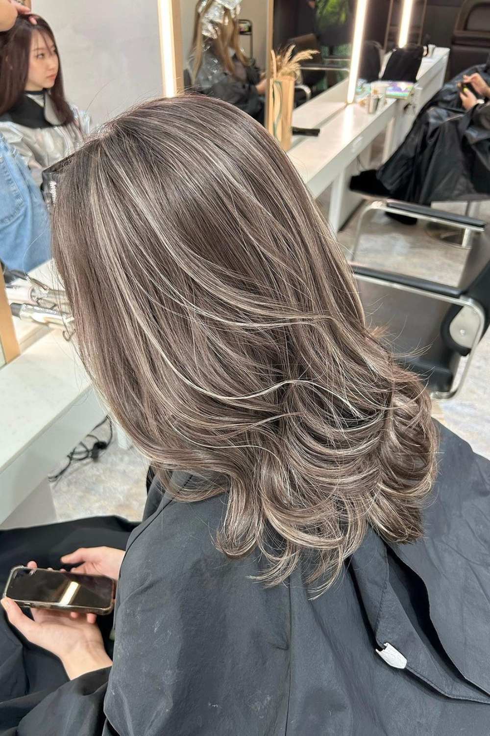 Elegant silver balayage with layered waves for sophistication