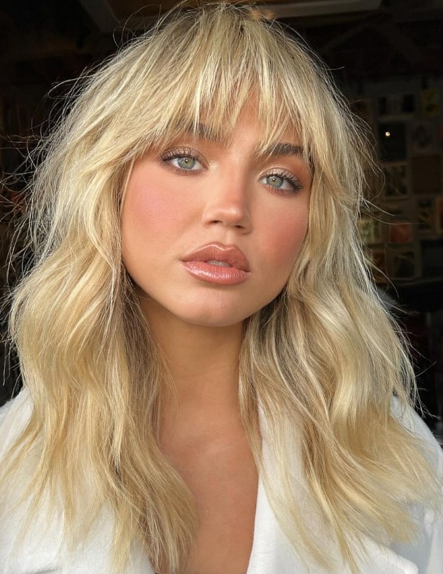 Textured blonde shag with bangs for a modern edge