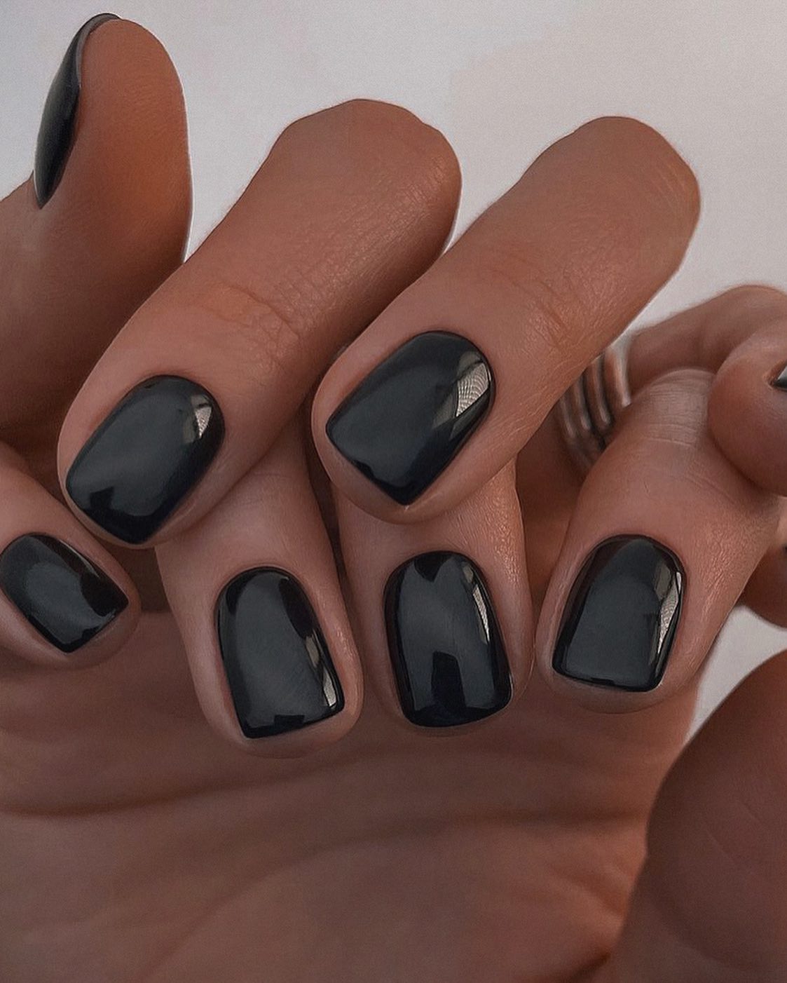 Glossy black squoval nails, elegant fall manicure.