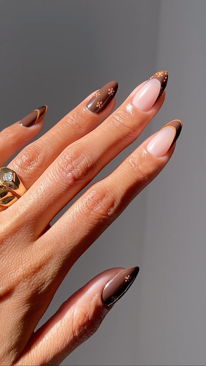 Chocolate almond French nails with floral details, elegant autumn style.
