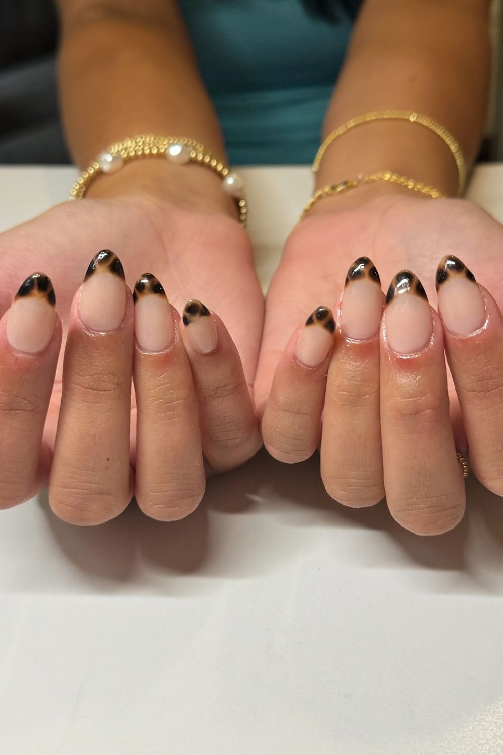 Leopard print tips on medium almond nails.