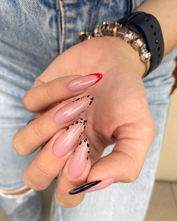 Mixed patterns on long almond nails.