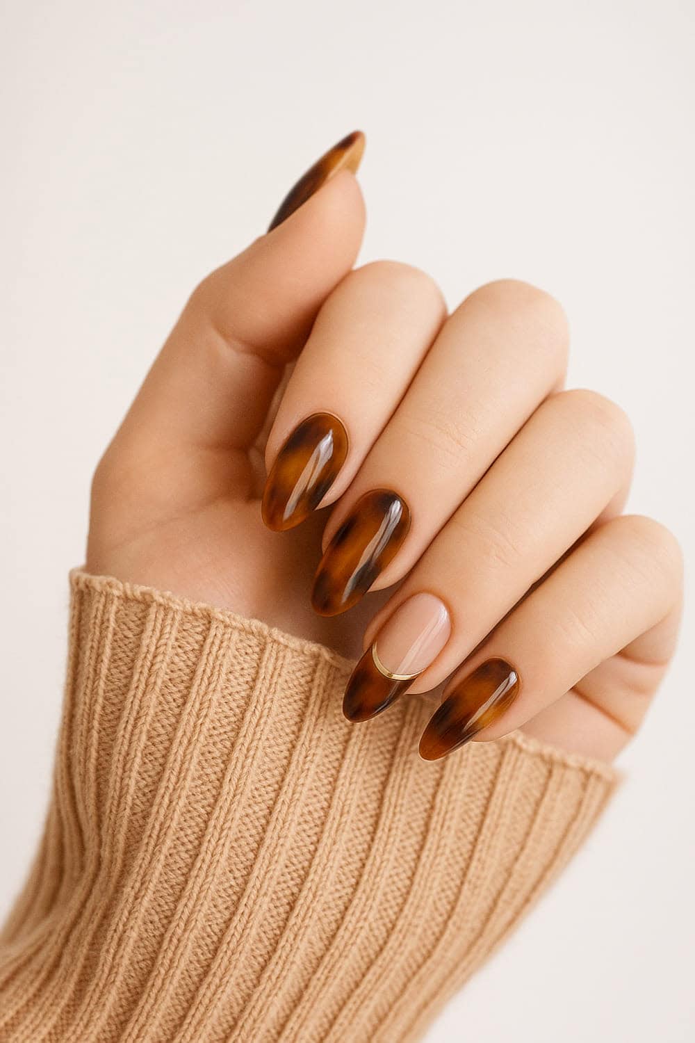 Tortoiseshell design on almond nails.