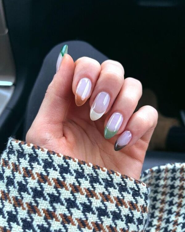 Multicolored French tips on almond nails.