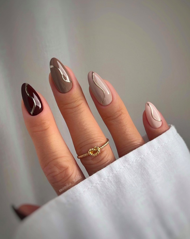 Almond nails with neutral and burgundy swirl design