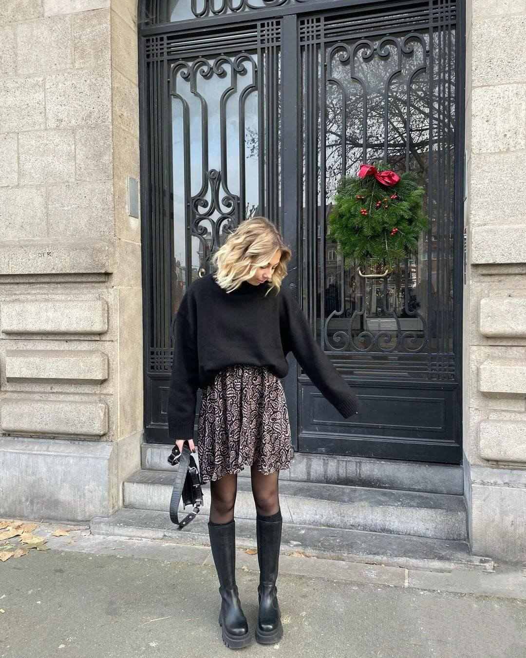 Black sweater with floral skirt and boots