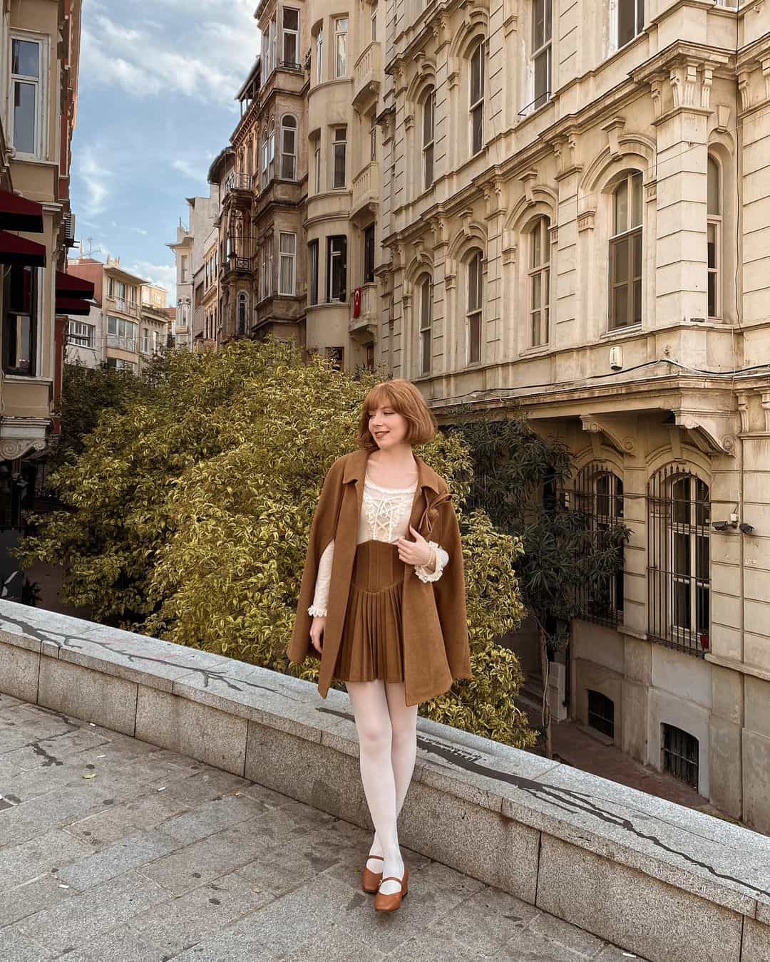 Cape with pleated skirt and tights